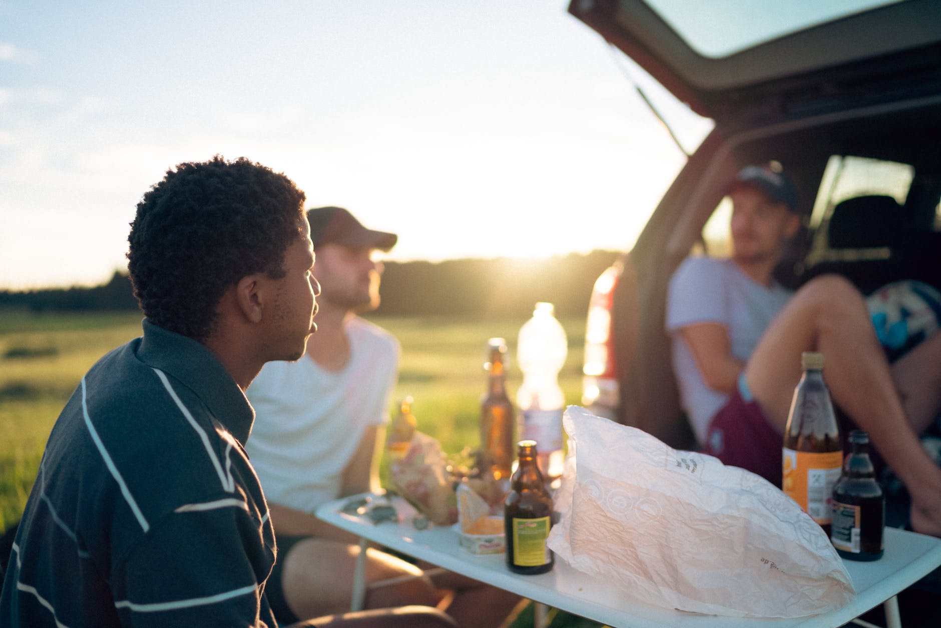 camping picnic from the car boot with a sunset and snacks